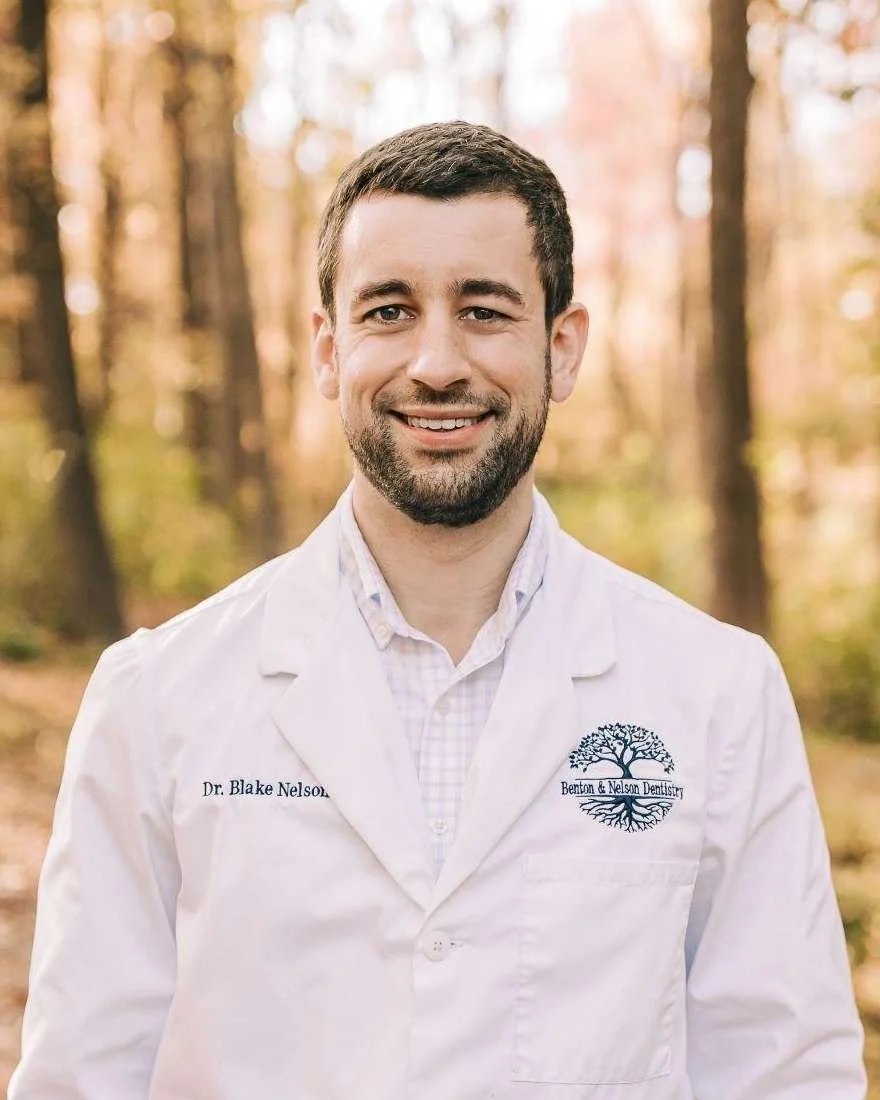 Dr. Blake Nelson, DDS, in his white coat.